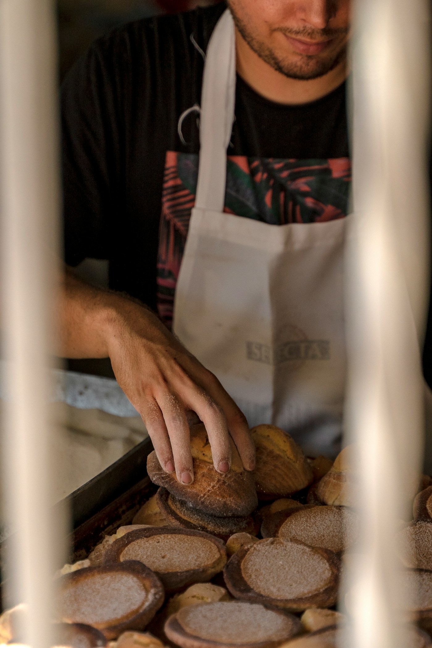 Jonas pulling bread from the tray