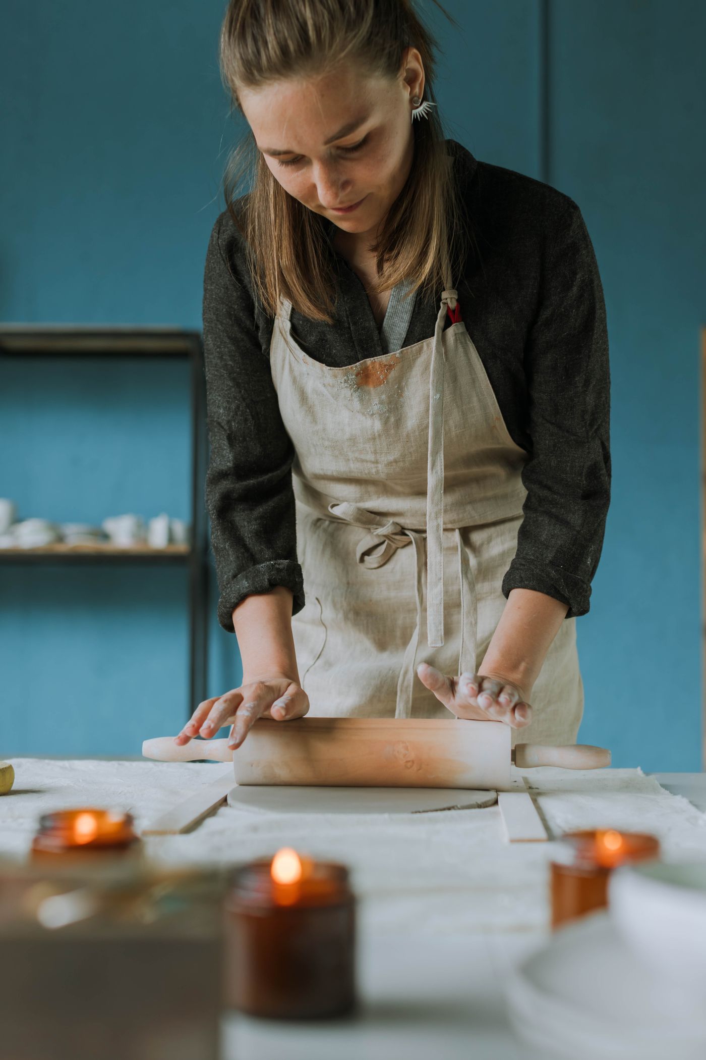 Sarah at the wheel, rolling clay